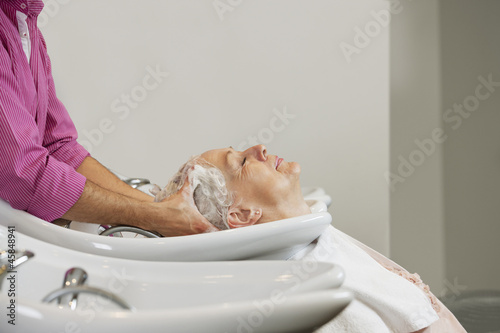 Photo: A senior woman having her hair shampooed at a hairdressing salon A senior woman having her hair shampooed at a hairdressing salon