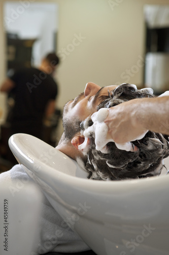 Photo: A male hairdresser shampooing a male clients hair A male hairdresser shampooing a male clients hair