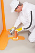 plumber applied waterproofing cuff brush on the floor of the bat