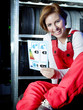 Female car mechanic showcases tire label in a tire stock