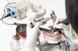 Photo: Dental technician working with articulator Dental technician working with articulator