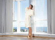 Photo: young happy woman enjoying sea view in hotel / room next to big young happy woman enjoying sea view in hotel / room next to big