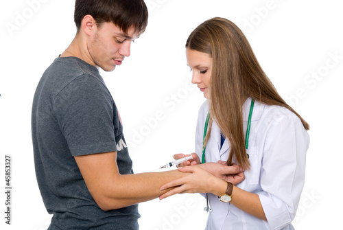 Photo: Woman nurse making vaccine to a patient Woman nurse making vaccine to a patient