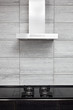 Gas-stove and cooking hood on modern minimalism style kitchen