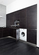 Build-in washing machine and cooker on modern black kitchen