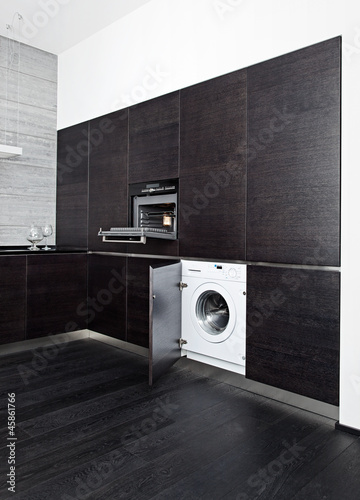 Photo: Build-in washing machine and cooker on modern black kitchen Build-in washing machine and cooker on modern black kitchen