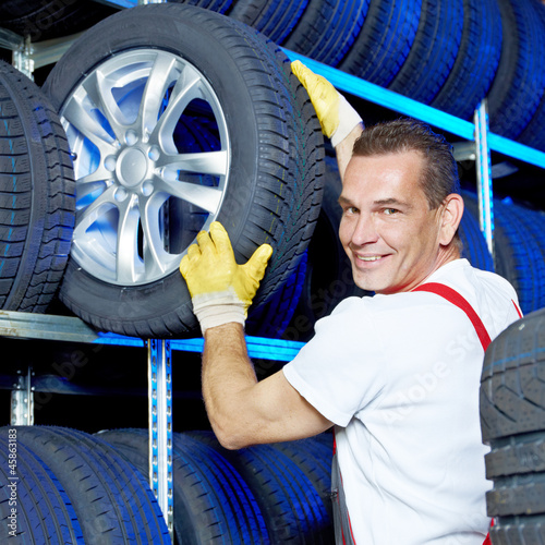 Photo: Car mechanic stores winter tires for tire changing Car mechanic stores winter tires for tire changing