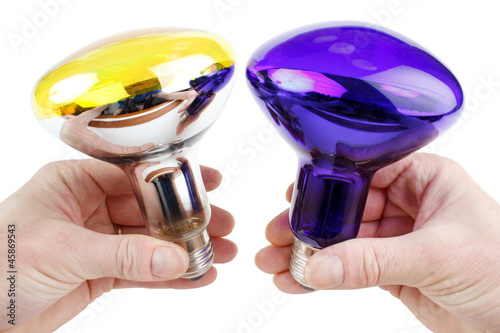 Photo: Color spot light bulbs in hand, isolated on white Color spot light bulbs in hand, isolated on white