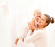 Mother and daughter play in the bedroom