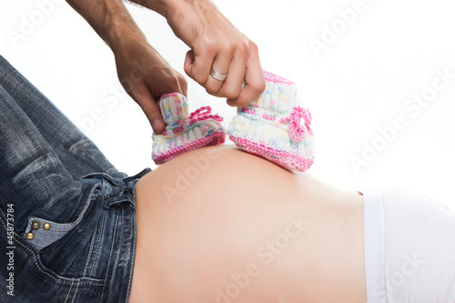 Photo: Little booties walk on a pregnant tummy Little booties walk on a pregnant tummy