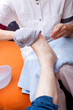 Altenpflegerin wäscht den Fuss einer Patientin