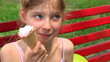 Child eating ice-cream outdoor.