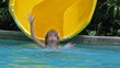 Child riding on water slide.