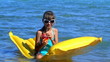 Child swimming on inflatable beach mattress.