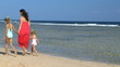 Mother with children on beach.