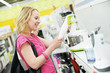 woman shopping at home appliance supermarket