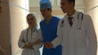 Group doctors and patient go at  hospital.
