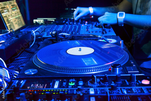 Photo: Dj mixes the track in the nightclub Dj mixes the track in the nightclub