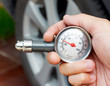 hand holding a tyre pressure gauge