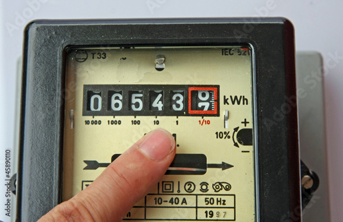 Photo: finger indicating the figures in an electric energy meter finger indicating the figures in an electric energy meter