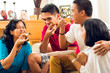 Foto: Asian people eating pizza at party Asian people eating pizza at party