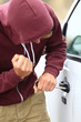 Youth breaking into a car