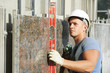 builder facade plasterer worker with level