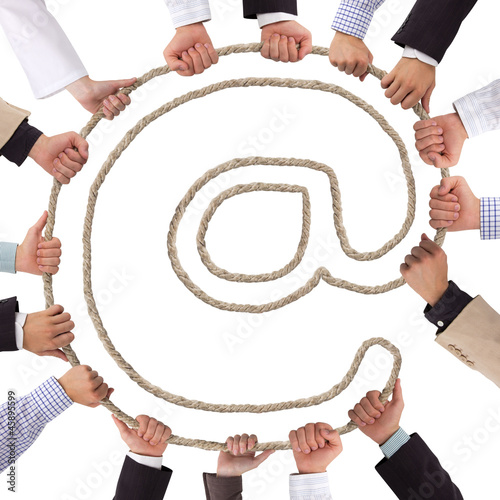 Photo: Business hands holding rope forming mail icon Business hands holding rope forming mail icon