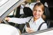 Photo: woman sitting in the car and holding mobile phone woman sitting in the car and holding mobile phone