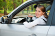 Photo: young woman driving the car and smiling young woman driving the car and smiling