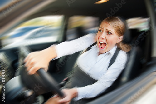 Photo: female driving the car and screaming female driving the car and screaming