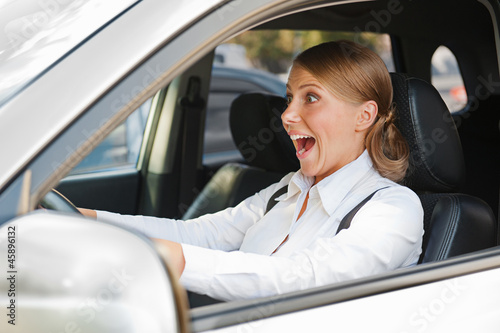 Photo: woman in panic is driving the car woman in panic is driving the car
