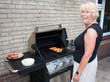Retired dutch senior woman grilling pork chops