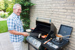 Retired dutch senior man grilling meat