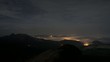 Night in the mountains - clouds above the city