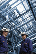 oil engineers with giant pipeline constructions