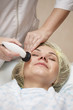 Photo: woman having a stimulating facial treatment from a therapist woman having a stimulating facial treatment from a therapist