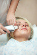 Photo: woman having a stimulating facial treatment from a therapist woman having a stimulating facial treatment from a therapist