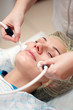 Photo: woman having a stimulating facial treatment from a therapist woman having a stimulating facial treatment from a therapist