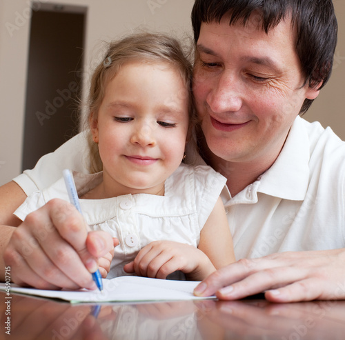Photo: Father helping daughter Father helping daughter