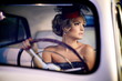 beautiful fashion girl in retro style sitting in old car