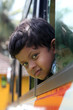 Handsome and cute little indian school kid looking back with hap