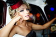 beautiful fashion girl in retro style sitting in old car