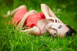 beautiful  brunette girl lying in green summer bright grass