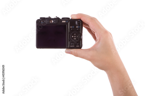 Photo: Hand photographing with a digital camera isolated on white Hand photographing with a digital camera isolated on white