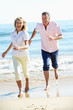 Senior Couple Enjoying Romantic Beach Holiday