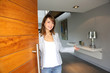Woman opening her house door to welcome people
