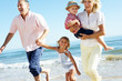 Grandparents And Grandchildren Enjoying Beach Holiday