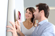 Couple choosing paperwall colour for their new home