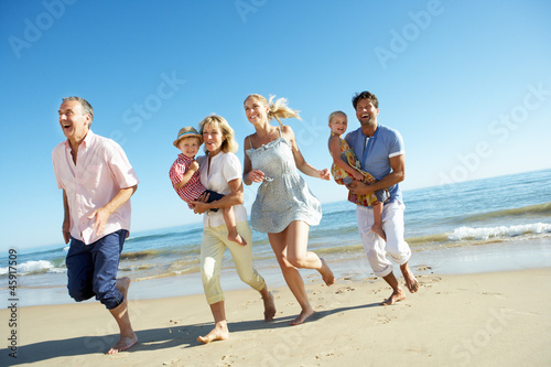 Photo: Multi Generation Family Enjoying Beach Holiday Multi Generation Family Enjoying Beach Holiday